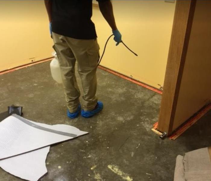 technician spraying antimicrobial after a residential water loss